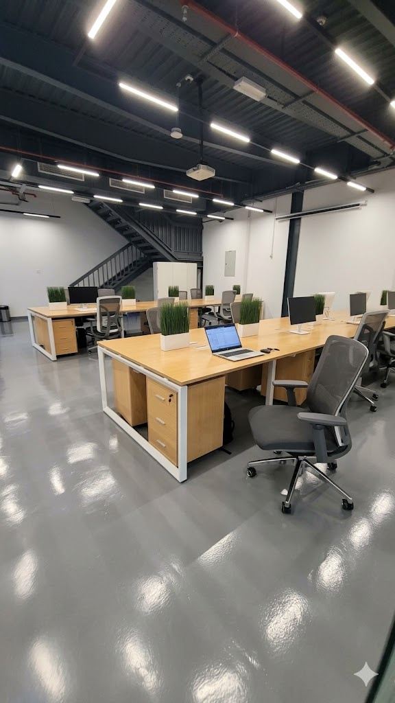 Office with timber desks under an exposed black ceiling